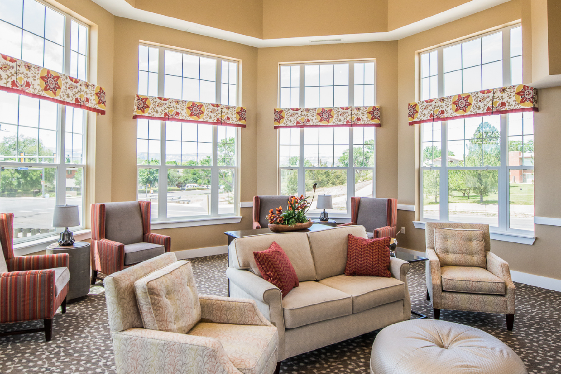 interior community seating area with tall windows landscape